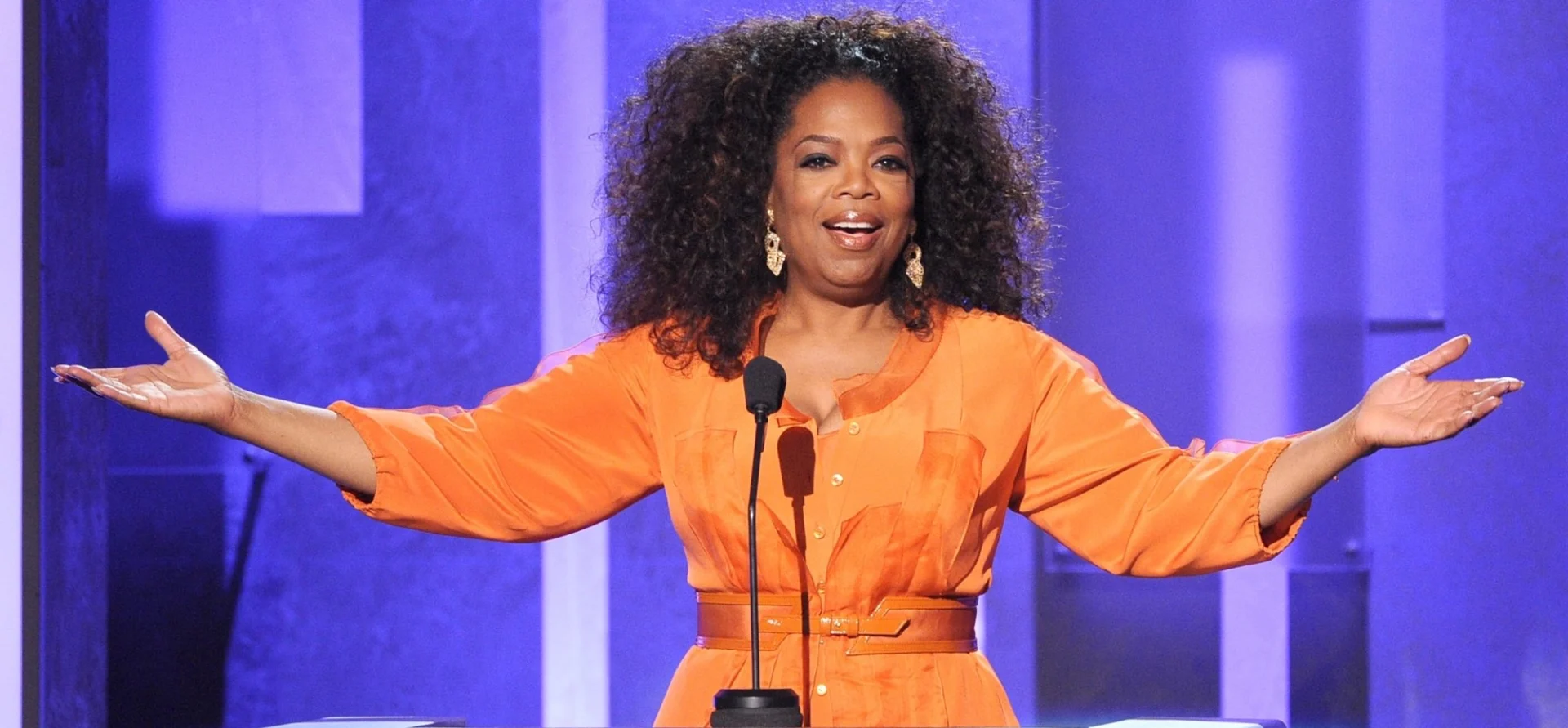 Oprah Winfrey speaking on stage about purpose and personal growth